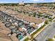 Aerial view featuring townhome community with pools, ample parking, and lush landscaping at 4802 Lullaby Ln, Kissimmee, FL 34746