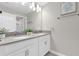 Bright bathroom featuring a double vanity with white cabinetry and a gray countertop at 4802 Lullaby Ln, Kissimmee, FL 34746