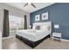 This bedroom features a large bed, natural light, and stylish decor at 4802 Lullaby Ln, Kissimmee, FL 34746