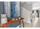 Inviting entryway with stylish decor, wooden console table, and an interesting blue painting at 4802 Lullaby Ln, Kissimmee, FL 34746