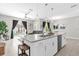 Bright and airy kitchen with a white island, stainless steel appliances, and views of the pool at 4802 Lullaby Ln, Kissimmee, FL 34746