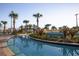 A relaxing lazy river with tropical landscaping, a bridge, and clear blue water for residents to enjoy at 4802 Lullaby Ln, Kissimmee, FL 34746