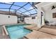 Private screened-in pool area with clear water, patio furniture, and a relaxing ambiance at 4802 Lullaby Ln, Kissimmee, FL 34746