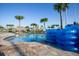 Beautiful community pool with tropical landscaping, a thatched tiki bar, and plenty of space to relax at 4802 Lullaby Ln, Kissimmee, FL 34746