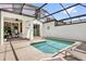 Private screened-in pool area with clear water, patio furniture, and sun loungers at 4802 Lullaby Ln, Kissimmee, FL 34746