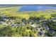 Scenic aerial view showcasing the neighborhood, a nearby lake, and verdant green space at 4951 Parkview Dr, St Cloud, FL 34771