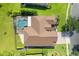 An overhead shot reveals the layout of the roof, the pool enclosure and surrounding greenery at 4951 Parkview Dr, St Cloud, FL 34771