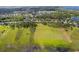 Serene aerial view of an expansive vacant plot, ready for development amidst lush greenery and a tranquil lake at 4951 Parkview Dr, St Cloud, FL 34771