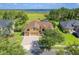 Expansive aerial view of a home with a lush lawn near a tranquil lake and green surroundings at 4951 Parkview Dr, St Cloud, FL 34771