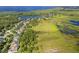 Beautiful aerial view of a large vacant land parcel surrounded by mature trees and a serene lake at 4951 Parkview Dr, St Cloud, FL 34771