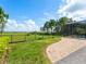 Backyard featuring a patio, green grass, and lake views with a screened pool enclosure nearby at 4951 Parkview Dr, St Cloud, FL 34771
