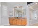 Bright bathroom with a wood vanity, decorative mirrors, and tiled floor at 4951 Parkview Dr, St Cloud, FL 34771
