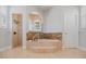 Luxurious bathroom featuring a soaking tub, granite countertop, and tiled shower stall at 4951 Parkview Dr, St Cloud, FL 34771