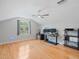 Large bonus room with hardwood floors, a ceiling fan and a window with outdoor views at 4951 Parkview Dr, St Cloud, FL 34771