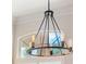 Close up view of dining room chandelier with filament style bulbs and matte black finish at 4951 Parkview Dr, St Cloud, FL 34771