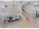 Dining room view with chandelier, table with six chairs, and stairway to the second floor at 4951 Parkview Dr, St Cloud, FL 34771