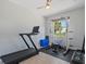 Home gym featuring a treadmill, weight rack, and window with a view at 4951 Parkview Dr, St Cloud, FL 34771