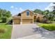 Beautiful single-Gathering home with a paver driveway, lush landscaping, and a two-car garage at 4951 Parkview Dr, St Cloud, FL 34771