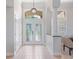 Bright and airy foyer with tile flooring, decorative lighting, and a view to the living area at 4951 Parkview Dr, St Cloud, FL 34771