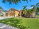 A well-maintained single Gathering house features a paver driveway, and manicured landscaping at 4951 Parkview Dr, St Cloud, FL 34771