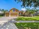 Charming two-story home featuring a three-car garage, lush lawn, and attractive landscaping at 4951 Parkview Dr, St Cloud, FL 34771