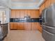 Spacious kitchen featuring stainless steel appliances and wooden cabinetry at 4951 Parkview Dr, St Cloud, FL 34771