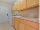Bright laundry room with ample cabinet space, countertop and modern washer and dryer at 4951 Parkview Dr, St Cloud, FL 34771