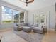 Bright living room featuring a large sectional sofa, tile flooring and an expansive view at 4951 Parkview Dr, St Cloud, FL 34771