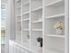 Close-up of custom built-in shelving with stylish decor items and natural light at 4951 Parkview Dr, St Cloud, FL 34771