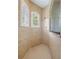 Spa-like shower with neutral tile, built-in niche, and rainfall shower head at 4951 Parkview Dr, St Cloud, FL 34771
