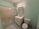 Small bathroom featuring tub with sliding glass doors, toilet, and vanity with a lighted mirror at 5564 Slash Pine Ct # 4, Orlando, FL 32811