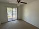 Bedroom with carpet, ceiling fan and sliding glass door access to the outdoor balcony at 5564 Slash Pine Ct # 4, Orlando, FL 32811