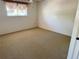 Empty bedroom with neutral carpet, a window with blinds, and white walls at 5564 Slash Pine Ct # 4, Orlando, FL 32811