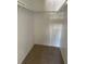 Walk-in closet with carpeted floor and upper racks on both sides for storage at 5564 Slash Pine Ct # 4, Orlando, FL 32811