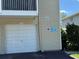 A single-car garage featuring visible house number, parking restrictions, and community fire prevention signage at 5564 Slash Pine Ct # 4, Orlando, FL 32811