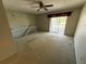 Living area with a ceiling fan and sliding glass doors leading to balcony, showcasing natural light at 5564 Slash Pine Ct # 4, Orlando, FL 32811