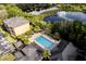 Aerial view showcasing the community's pool, lake, landscaping, and residential buildings at 6029 Westgate Dr # 726, Orlando, FL 32835