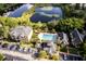 Aerial view capturing the community's amenities including a pool, lake, and well-maintained buildings at 6029 Westgate Dr # 726, Orlando, FL 32835