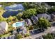 Aerial view highlighting the community layout, pool, lake, buildings, and parking areas at 6029 Westgate Dr # 726, Orlando, FL 32835