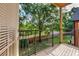 Private balcony with a metal railing offering serene views of the lush green backyard at 6029 Westgate Dr # 726, Orlando, FL 32835