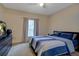 A comfortable bedroom featuring a ceiling fan, large window, and a dresser at 6029 Westgate Dr # 726, Orlando, FL 32835