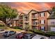 Exterior view of the multi-story apartment buildings with well-kept landscaping and ample parking at 6029 Westgate Dr # 726, Orlando, FL 32835