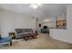 Inviting living room area with a sofa, coffee table, workspace, and kitchen view at 6029 Westgate Dr # 726, Orlando, FL 32835