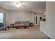 A cozy living room with carpet, a ceiling fan, natural light, and neutral paint at 6029 Westgate Dr # 726, Orlando, FL 32835