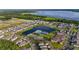 Aerial view of a Primary planned community featuring lake, pool, clubhouse, and numerous single-Gathering homes at 640 Bayern Ln, Debary, FL 32713