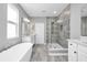 Modern bathroom featuring a glass shower, soaking tub, and white vanity with double sinks at 640 Bayern Ln, Debary, FL 32713