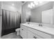 Bathroom featuring double sinks, vanity and shower with modern black and white striped shower curtain at 640 Bayern Ln, Debary, FL 32713