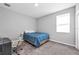 Bedroom with neutral walls and carpet, featuring a small bed and a rolling desk chair at 640 Bayern Ln, Debary, FL 32713
