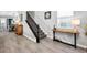 Inviting entryway showcasing wood-look tile floors and staircase with elegant black iron railings at 640 Bayern Ln, Debary, FL 32713