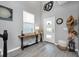 Bright foyer with stylish decor, wood-look floors, and ample natural light from the front door and window at 640 Bayern Ln, Debary, FL 32713